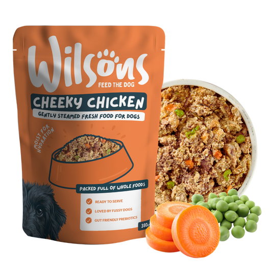 Wilsons Cheeky Chicken fresh pouch beside a bowl of the food with carrots and peas