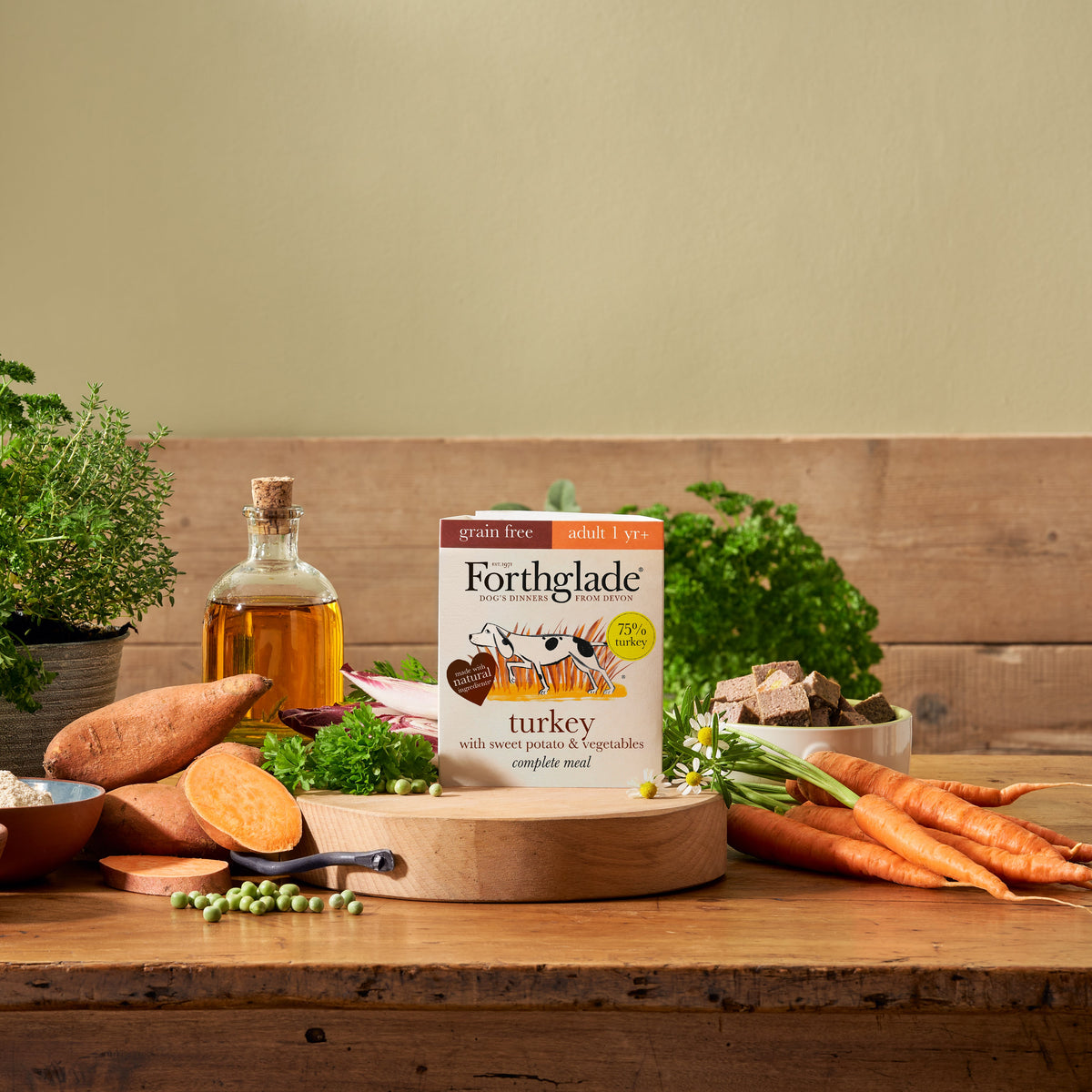 Forthglade grain free adult turkey with sweet potato and vegetables tray on a wooden table with fresh ingredients