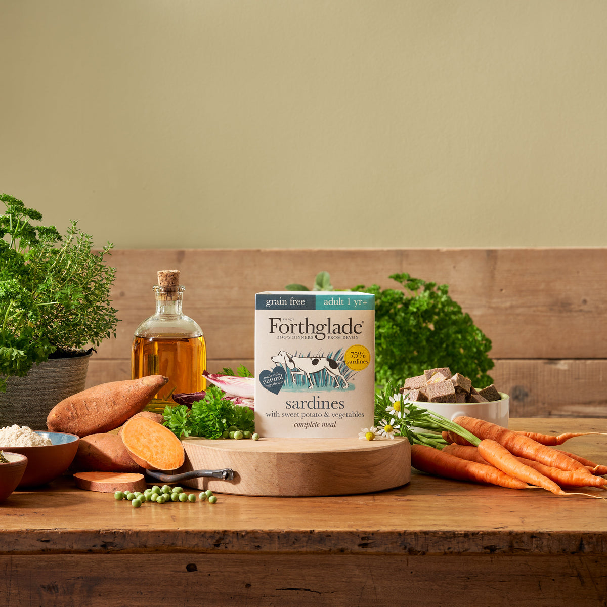 Forthglade grain free adult sardines with sweet potato and vegetables tray on a wooden table with fresh ingredients
