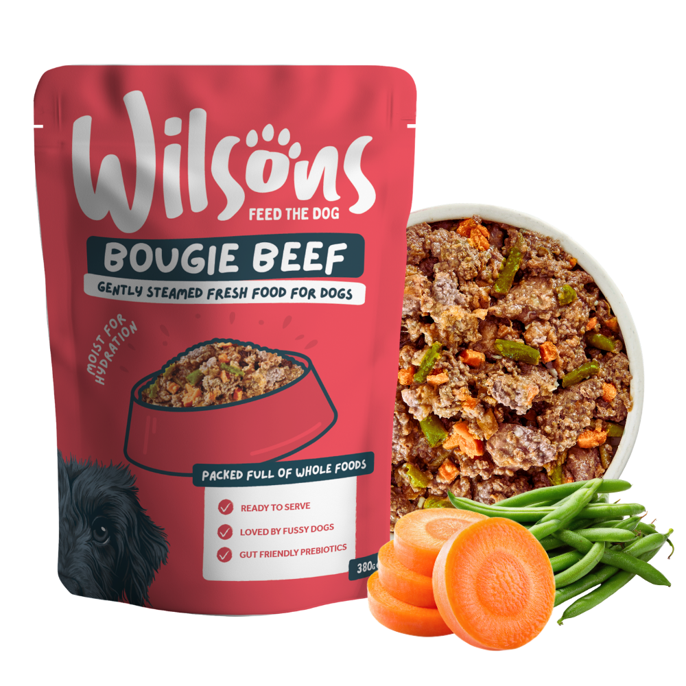 Wilsons Bougie Beef fresh pouch beside a bowl of the food with carrots and green beans