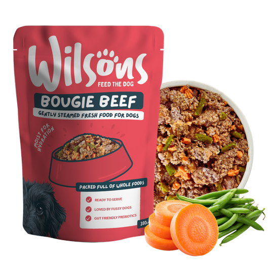 Wilsons Bougie Beef fresh pouch beside a bowl of the food with carrots and green beans