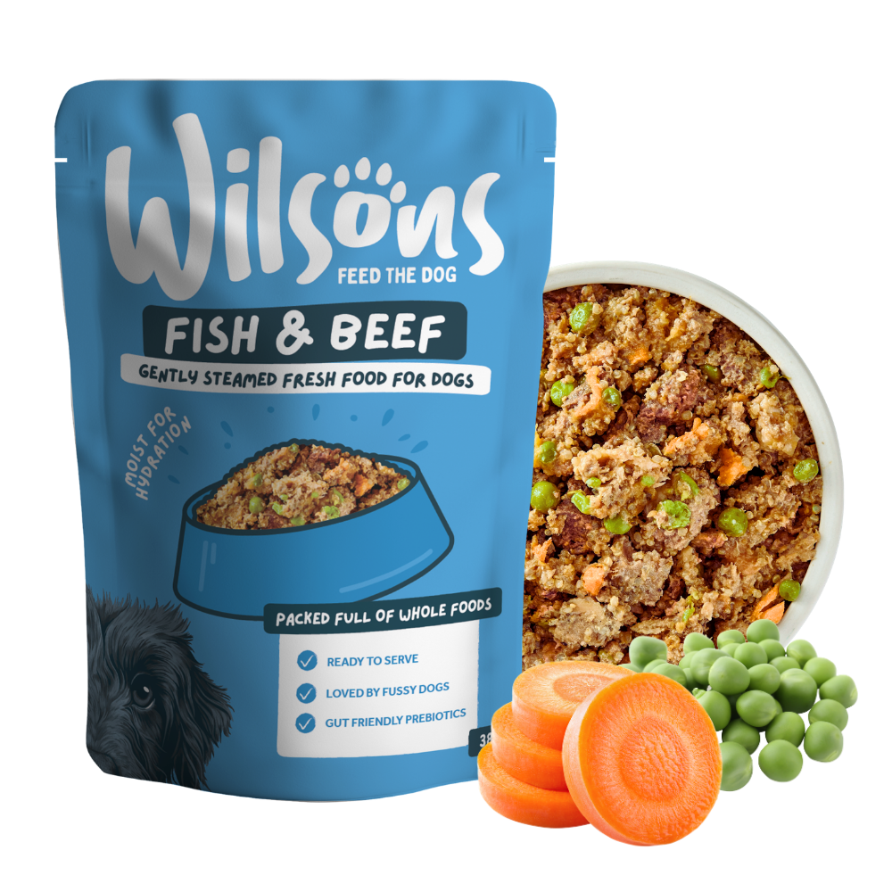 Wilsons Fish and Beef fresh pouch beside a bowl of the food with carrots and peas