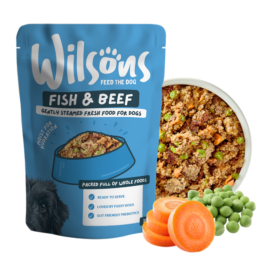 Wilsons Fish and Beef fresh pouch beside a bowl of the food with carrots and peas