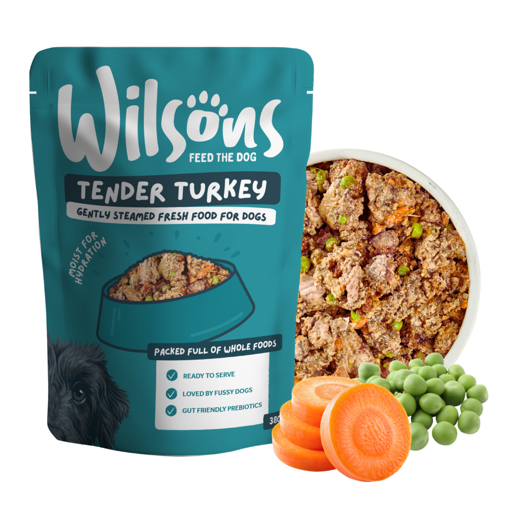 Wilsons Tender Turkey fresh pouch beside a bowl of the food with carrots and peas