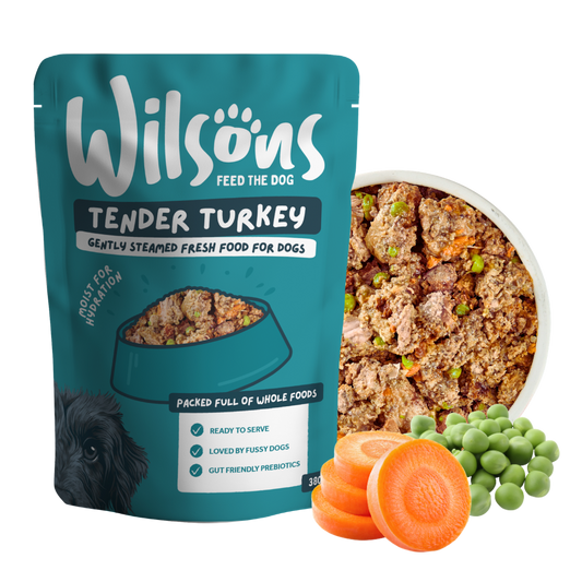 Wilsons Tender Turkey fresh pouch beside a bowl of the food with carrots and peas